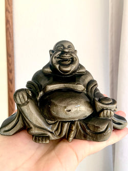 Large Golden Sheen Obsidian Happy Buddha Statue held up in natural light with a light background