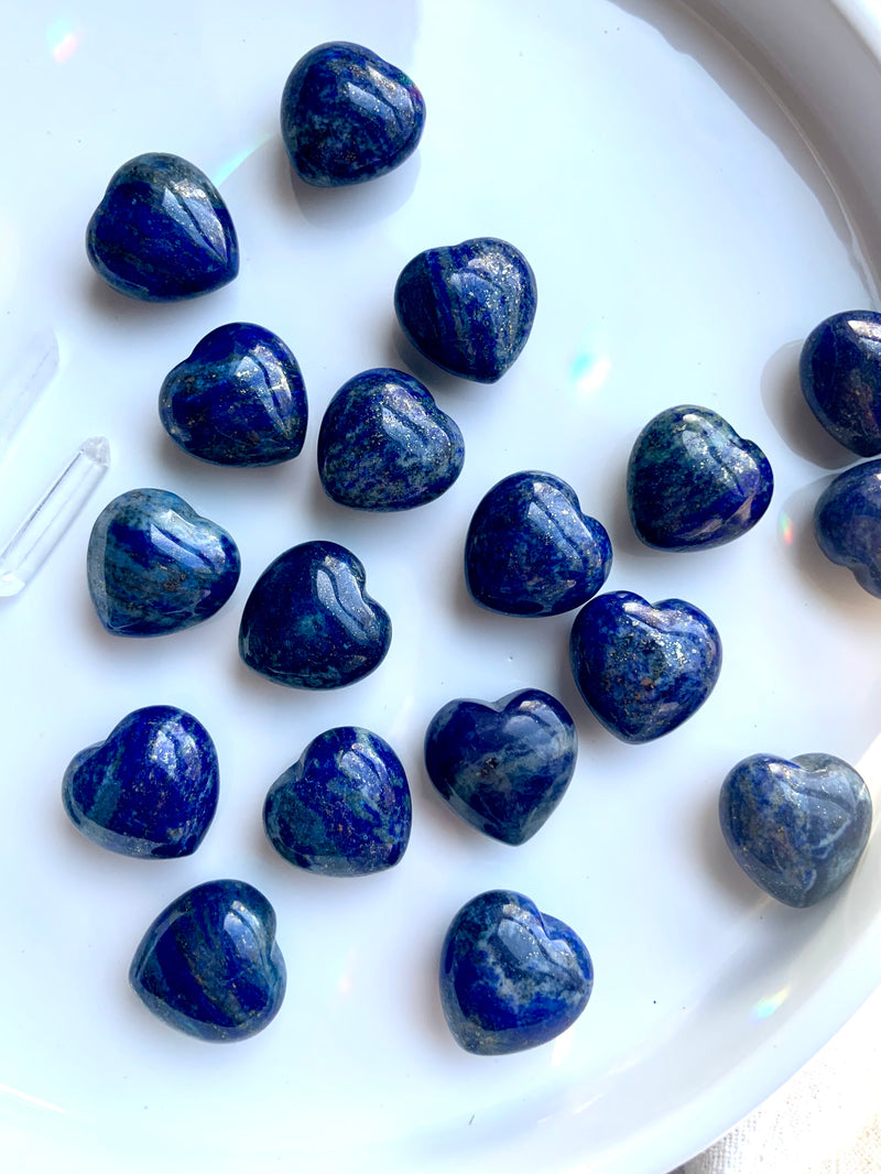 deep blue mini lapis hearts on a white background