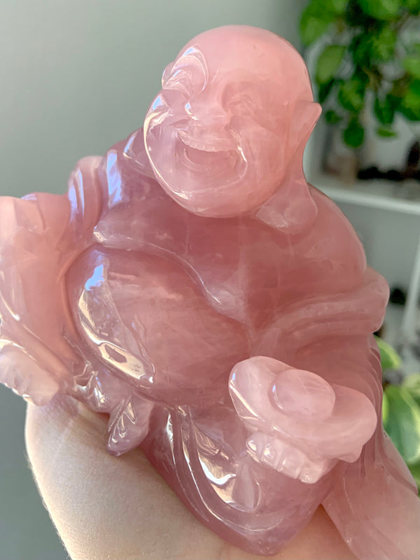 Close up view of the hand carved Rose Quartz Buddha Statue