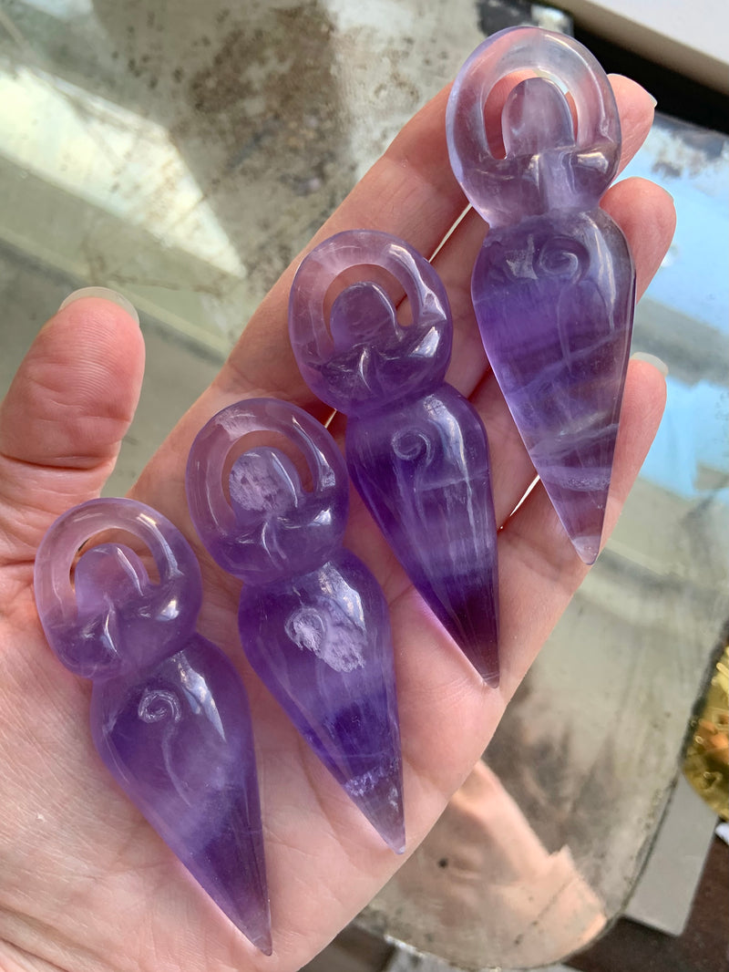 Beautiful translucent purple fluorite crystal goddess figurines with the spiral of life on their belly. You can pick your favorite!